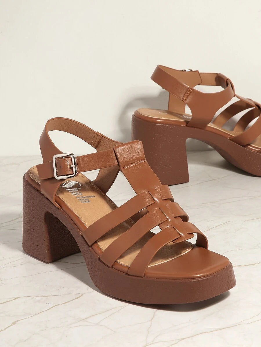 Elevate your seasonal wardrobe with these Block Heel Caged Strap Sandals for Women, a stylish combination of modern elegance and everyday comfort. Designed with an eye-catching caged strap silhouette and an open-toe design, these heels add a sophisticated finish to everything from flowy dresses and tailored pants to jumpsuits and denim.