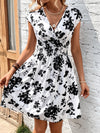 This Blooming Beauty <a href="https://canaryhouze.com/collections/women-dresses" target="_blank" rel="noopener">dress</a> features a stunning floral print and a surplice neck design. The perfect blend of style and sophistication, this dress will elevate your wardrobe and make you stand out in any occasion. Add this versatile piece to your collection and exude confidence with every wear.