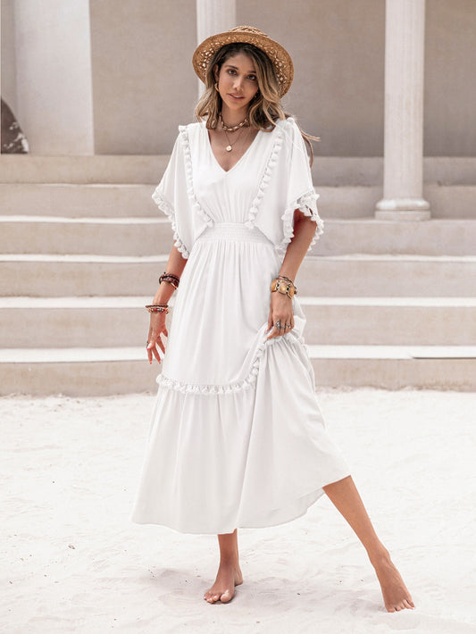 Introducing our Boho Chic Women's Tassel Trim Dress with Ruffle Hem. Perfect for any occasion, this dress features a stylish tassel trim and flowy ruffle hem. Stay on trend and comfortable with this unique piece.