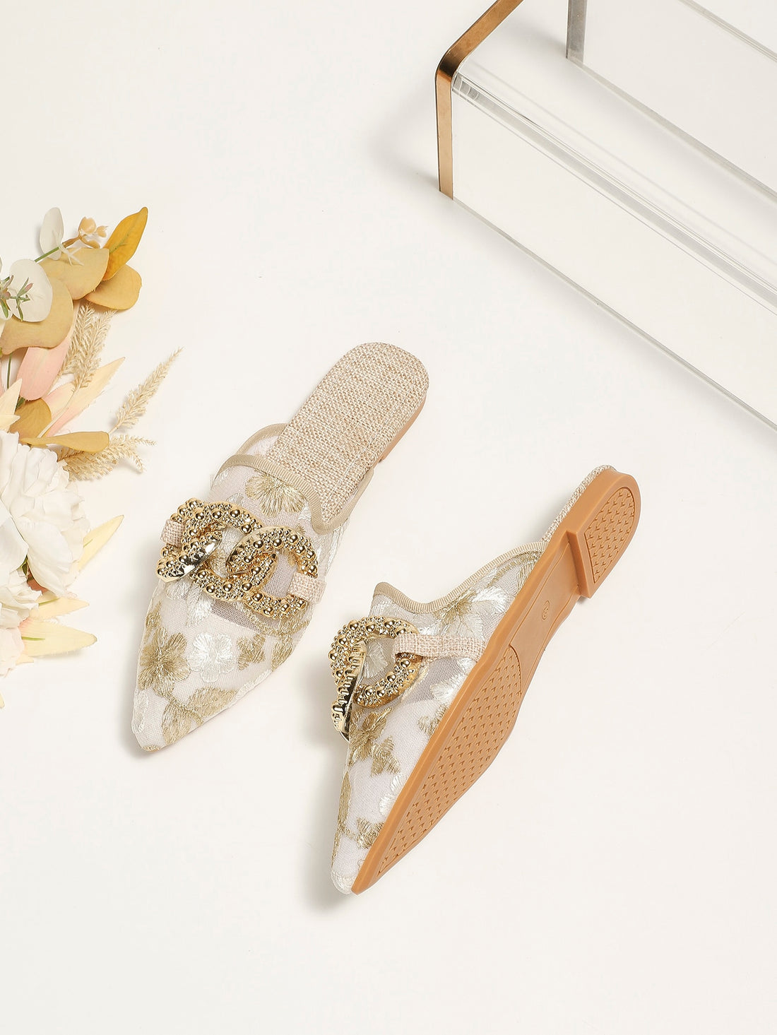 These chic sandals feature elegant embroidered mesh detailing and a statement metal buckle for a stylish and unique look. The breathable design provides comfort and the sturdy metal buckle ensures durability. Elevate your summer wardrobe with these fashionable flat sandals.