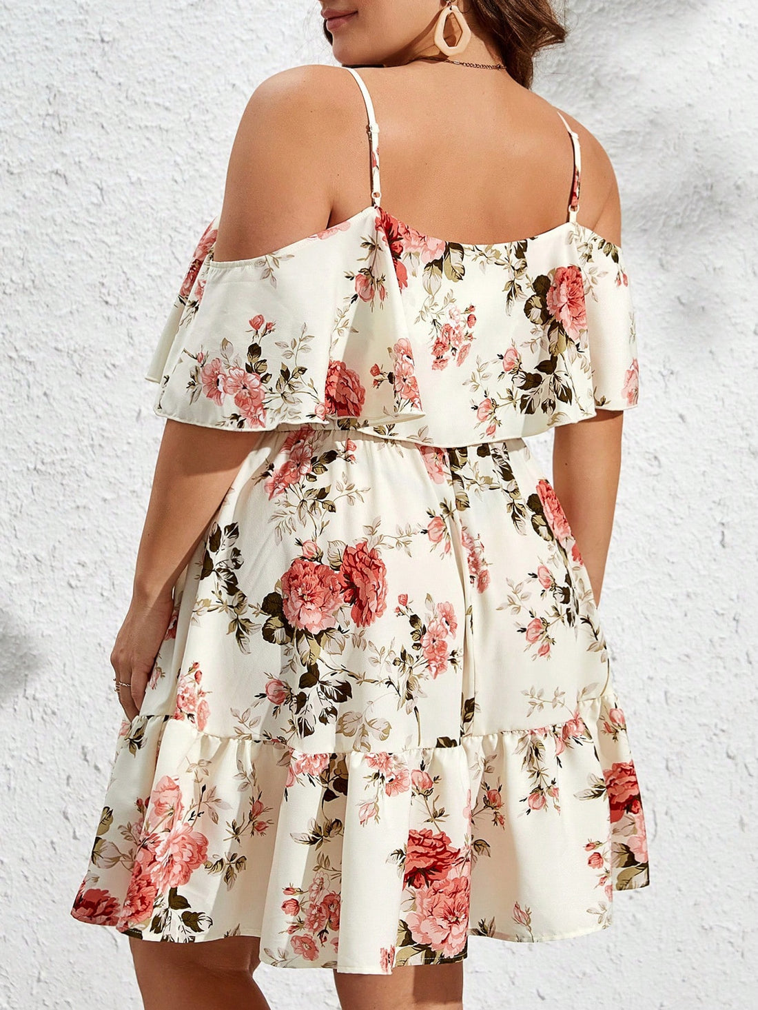 Add a touch of elegance with this floral plus size cold shoulder dress. The ruffle hem detail adds a charming touch while the cold shoulder design keeps you cool and trendy. Perfect for any occasion, this dress will have you feeling confident and stylish.