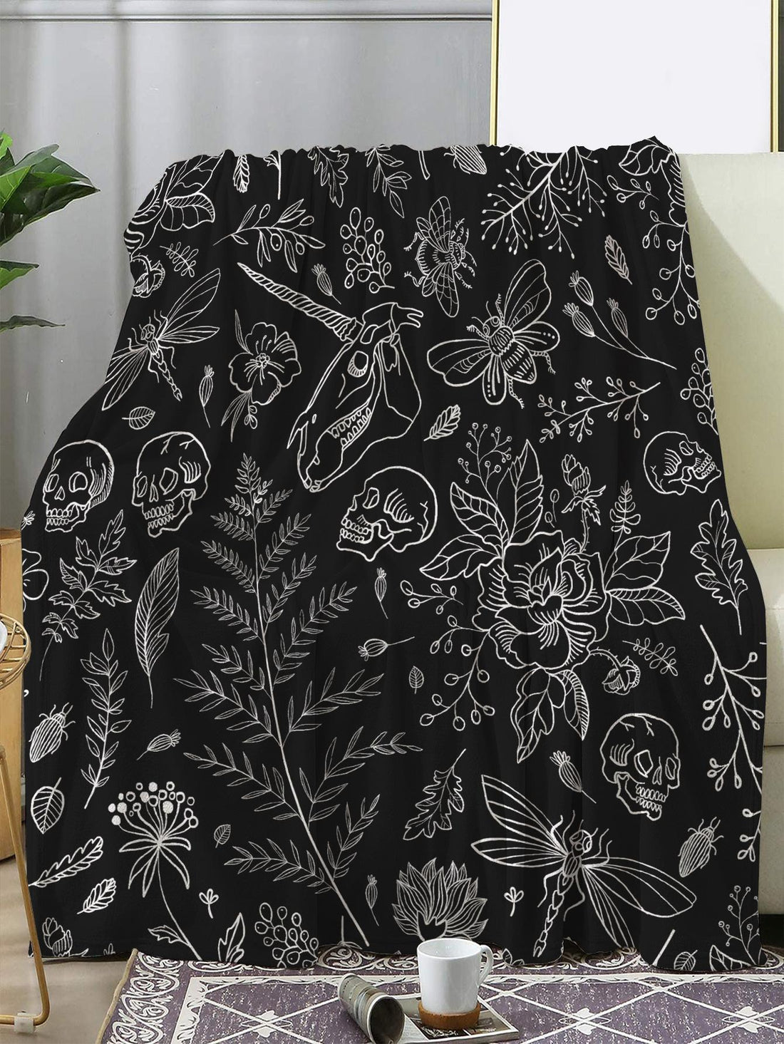 Cozy up with the Skull Plant Pattern Blanket, the perfect home decor essential for both style and comfort. Made with a soft and warm material, this blanket features a unique and trendy skull plant pattern. Add a touch of coziness to any room with this must-have piece.