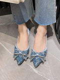 Top view of icy blue jeweled slip-on pumps with symmetrical oversized bows