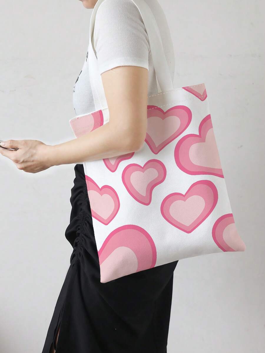 Carry your essentials in style with this charming heart print shopper bag. Designed for teen girls and women, this spacious tote features a playful heart pattern that adds personality to any outfit. Perfect for school, shopping trips, or everyday adventures, the roomy interior keeps your belongings organized and accessible. Durable construction ensures it withstands daily wear, while the comfortable handles make carrying effortless.