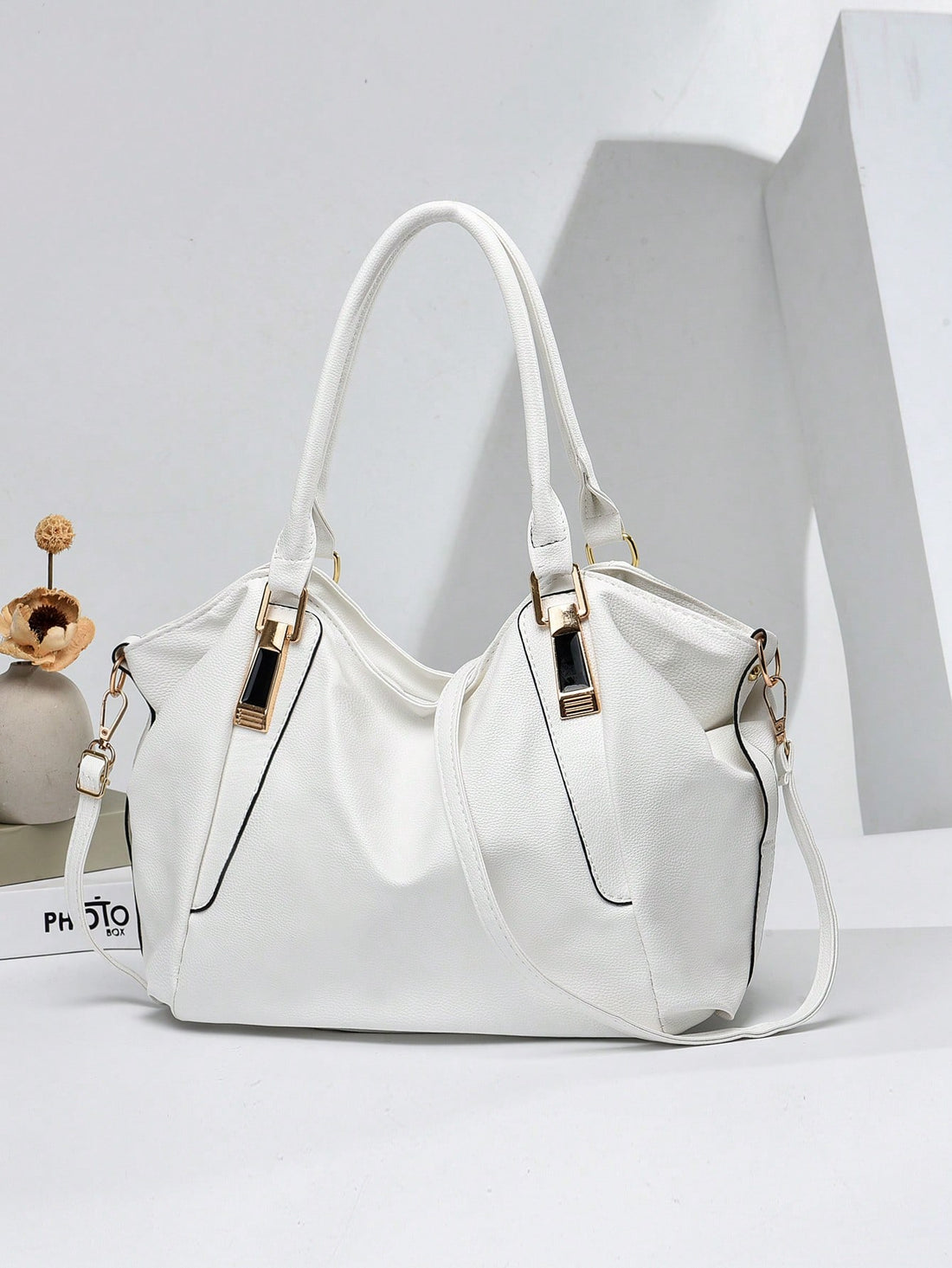 Carry your essentials with a dash of flair! This medium tote features a chic litchi-embossed texture and eye-catching metal accents, making it as stylish as it is practical. Perfect for busy moms on the go or as a thoughtful Mother’s Day gift, it blends fashion with function effortlessly. Whether running errands or heading out on a fun adventure, this tote keeps you organized and looking fabulous every step of the way.