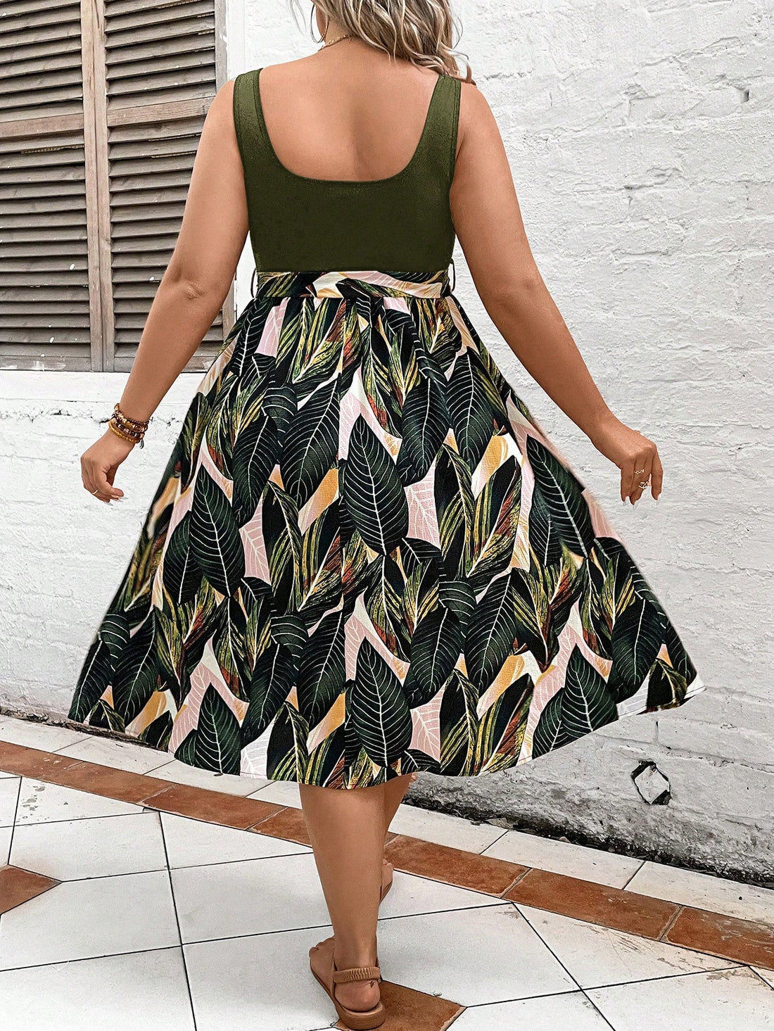 Escape to paradise in our Tropical Escape plus-size belted dress! With a vibrant print that will make you stand out in any crowd, this dress is perfect for any summer occasion. The belted waist adds a flattering touch, making you feel confident and stylish. Don't miss out on this must-have dress!