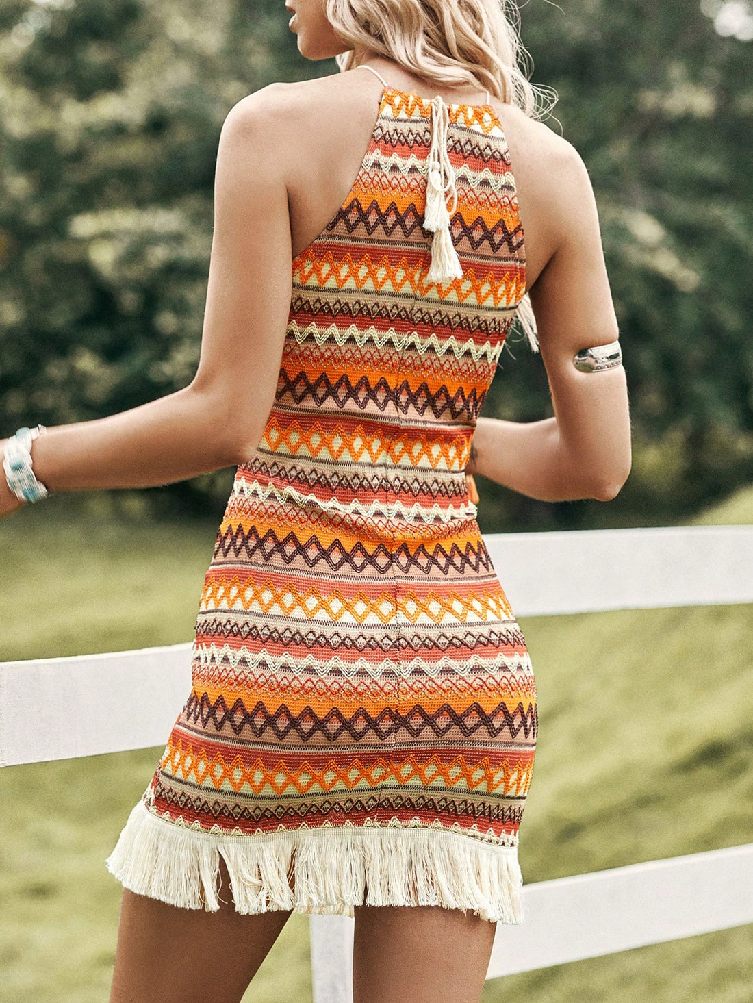 Elevate your spring concert style with our Chic Chevron Print Bodycon Dress. The trendy chevron print and fringe hem add a touch of fun, while the bodycon silhouette flatters your figure. Perfect for dancing the night away in style.