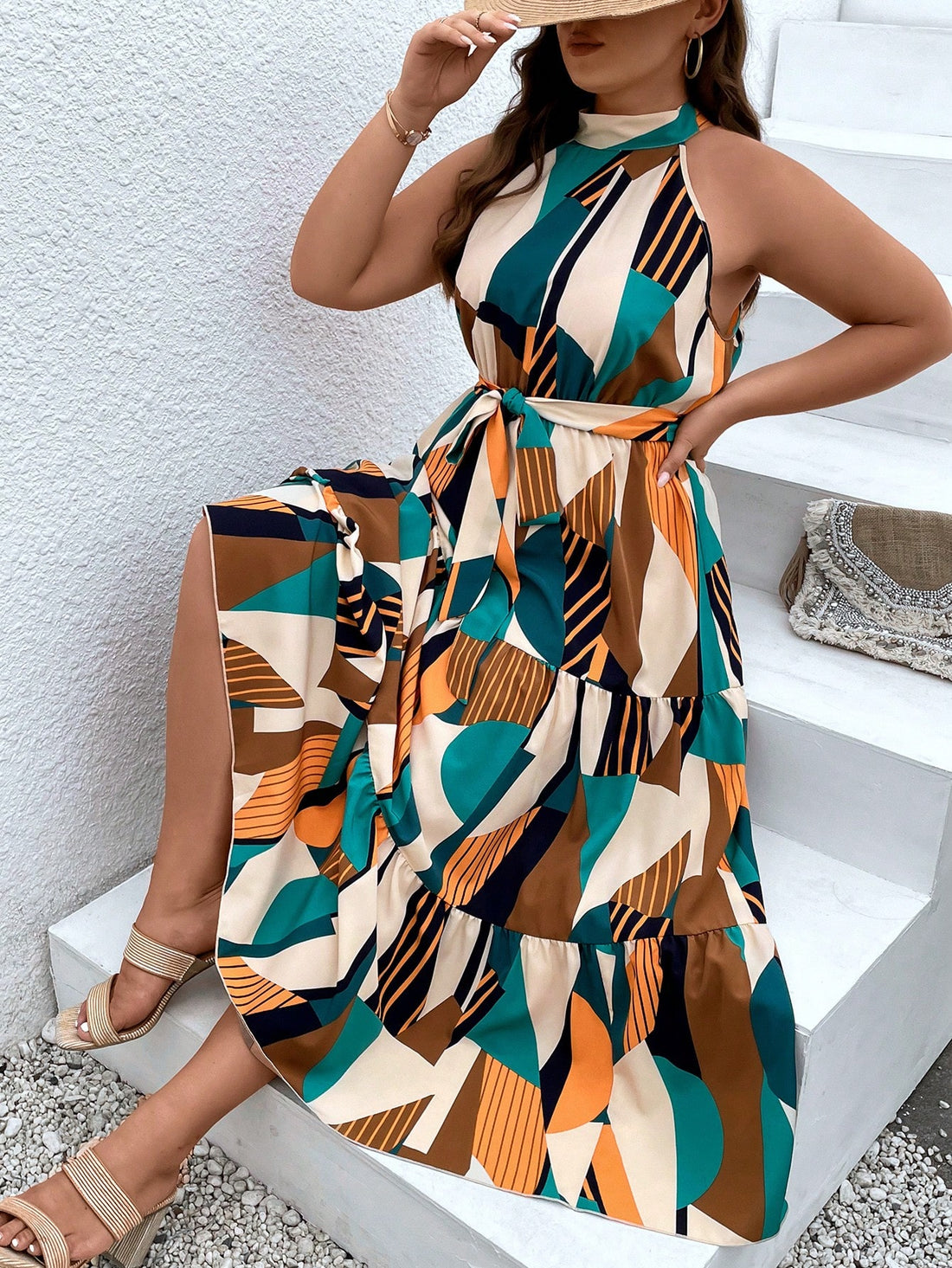 This Chic Geo Print Plus Size Halter Maxi Dress is a must-have for your wardrobe! The bold geo print adds a touch of fun to the classic halter style, while the ruffled hem and belt accentuate your curves. Perfect for any occasion, this dress is both stylish and comfortable.