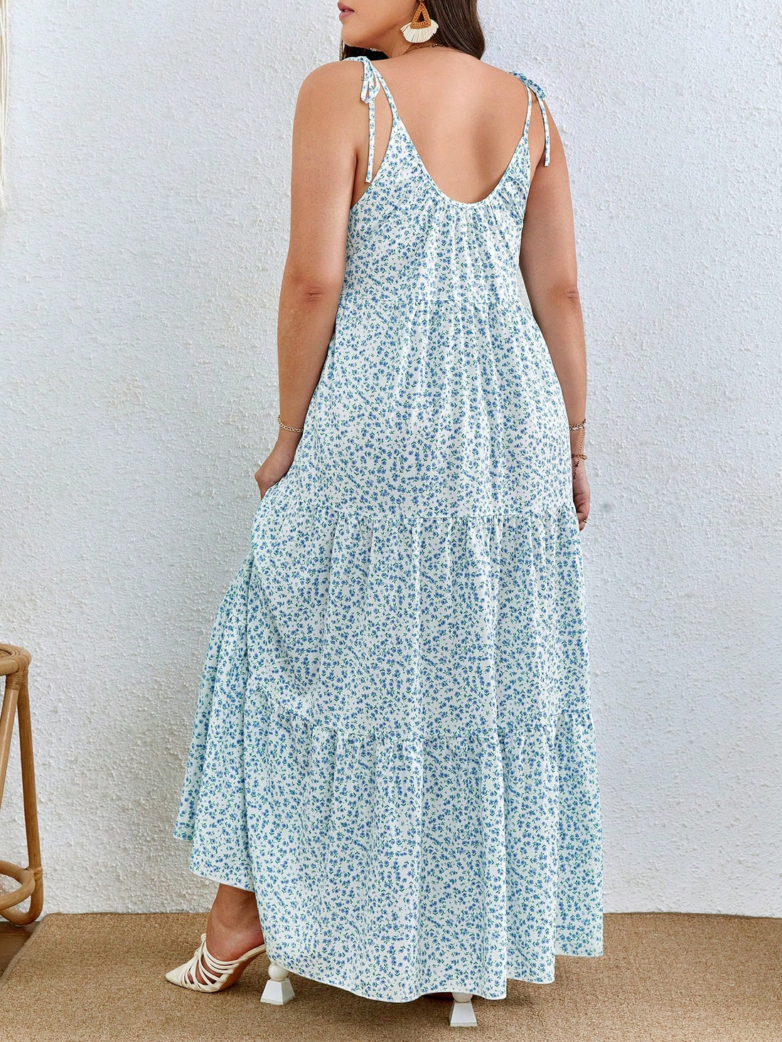 Add a touch of whimsy to your wardrobe with the Floral Elegance: Plus Size Ditsy Print Tie Shoulder Ruffle Hem Cami Dress. The delicate ditsy print and playful ruffle hem bring a sense of charm and elegance to this cami dress. The tie shoulder detail adds a unique touch to this flowy and flattering plus size dress.