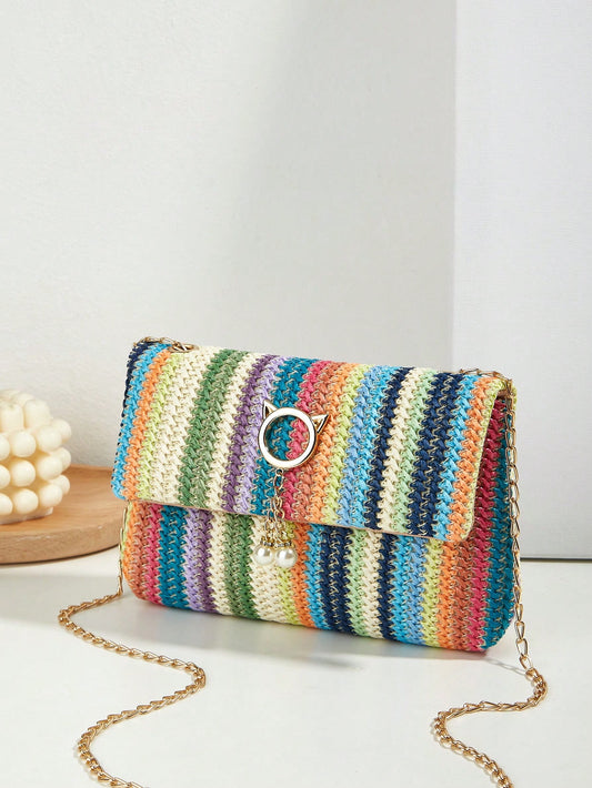 This Rainbow Dreams straw <a href="https://canaryhouze.com/collections/canvas-tote-bags" target="_blank" rel="noopener">bag</a> is perfect for your vacation getaway with its colorful striped pattern. The flap closure keeps your essentials secure while adding a touch of style. Its lightweight design makes it easy to carry around, making it the ideal travel companion.
