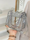 Elevate your style with the Crystal Clear Rhinestone Chain Bag. This chic and stylish mini crossbody features a dazzling rhinestone chain that adds a touch of glamour to any outfit. Made with high-quality materials, it's both functional and fashionable. Perfect for a night out or adding some sparkle to your everyday look.