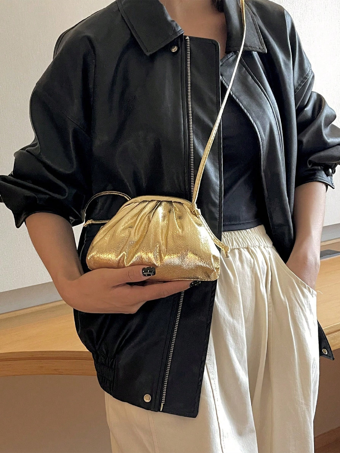 Be the ultimate funky punk with our Golden Metallic Mini Ruched Bag. Its unique design adds a touch of streetwear flair to any outfit. The ruched texture and metallic finish make it a standout accessory, perfect for making a bold statement. 