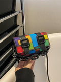 Close-up of acrylic decoration and chain detail on the mini square bag