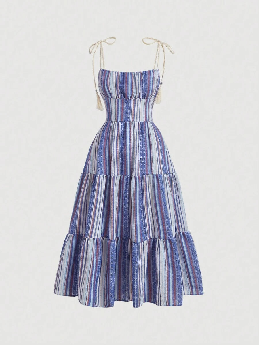 Front view of blue multicolor striped cami dress with tie straps, ruched bust, and tiered ruffle hem