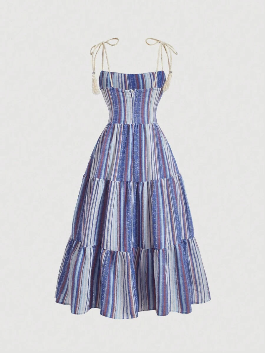 Front view of blue multicolor striped cami dress with tie straps, ruched bust, and tiered ruffle hem
