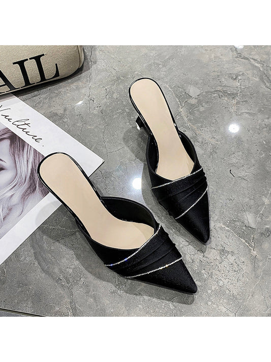 Elevate your style with our Sparkling Style: Black Rhinestone Pointed Toe High Heels <a href="https://canaryhouze.com/collections/women-canvas-shoes" target="_blank" rel="noopener">Slippers</a>. These stunning heels feature sparkling rhinestones and a sleek, pointed toe design. Perfect for adding a touch of glamour to any outfit. Make a statement and stand out from the crowd with these chic and elegant slippers.