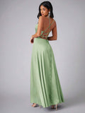 Back view of mint green dress showing crossed open-back straps