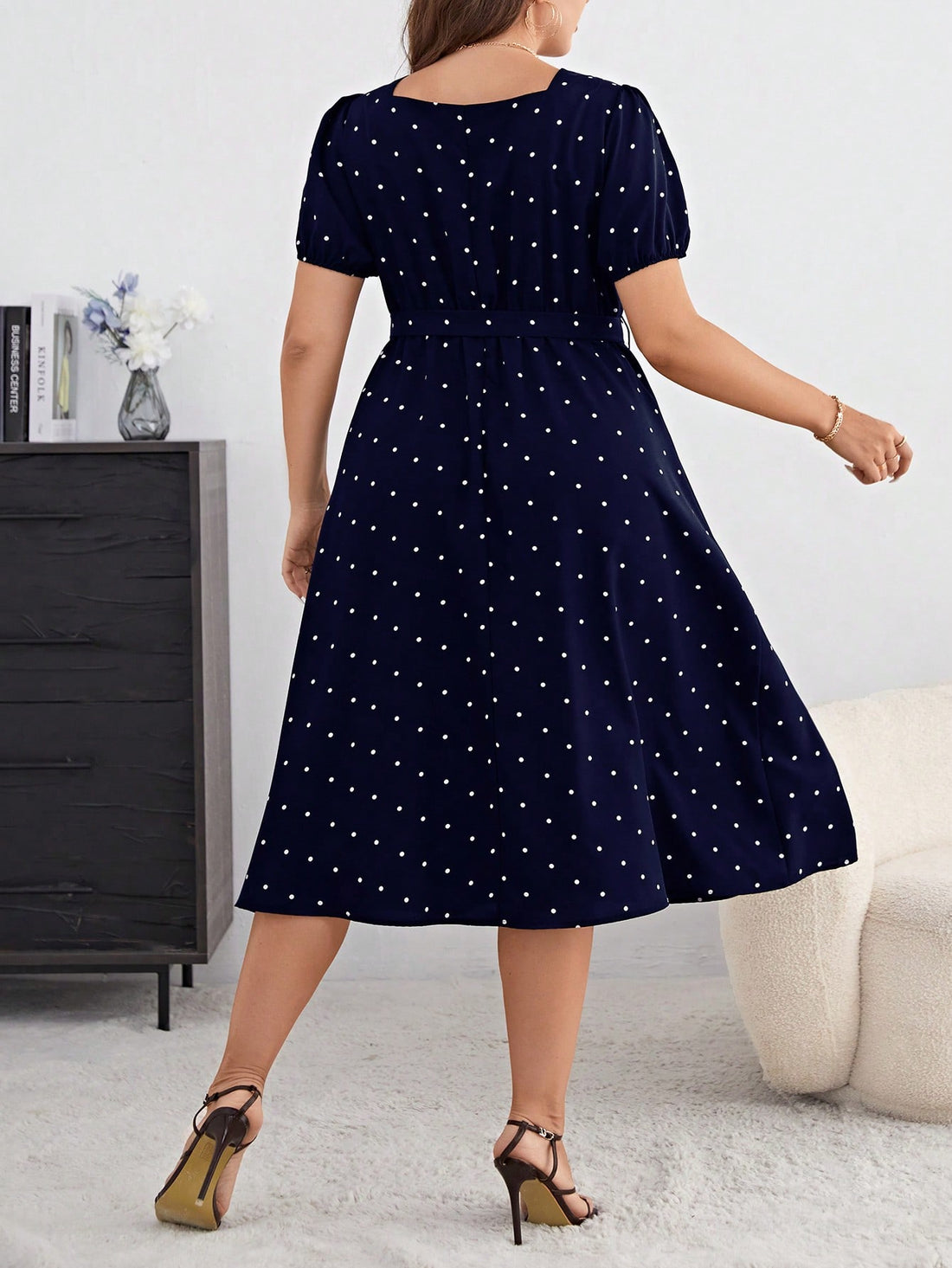 Step into summer with this playful plus size blue polka dot dress, featuring charming puff sleeves and a flattering belt to highlight your waist. Its light, breezy fabric keeps you cool and comfortable, while the classic polka dot pattern adds a fun, timeless touch to your wardrobe. Perfect for sunny days and casual outings, this dress effortlessly blends elegance with a spirited vibe.