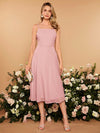 This elegant Pink Enchantment Bridesmaid Dress features a stylish solid tie-back cami design, perfect for any special occasion. Crafted with high-quality materials, this dress offers both comfort and style. With its playful pink color, it is sure to enchant and impress at any event.