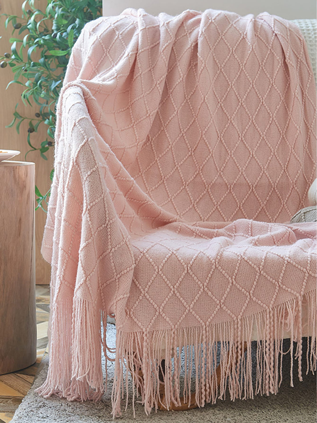 This cozy knitted <a href="https://canaryhouze.com/collections/blanket" target="_blank" rel="noopener">blanket</a> with tassels is the perfect addition to your home or office space. Its soft texture and stylish design make it versatile for use as a blanket, office nap companion, or even a fashionable shawl. Stay warm and stylish with this must-have accessory.