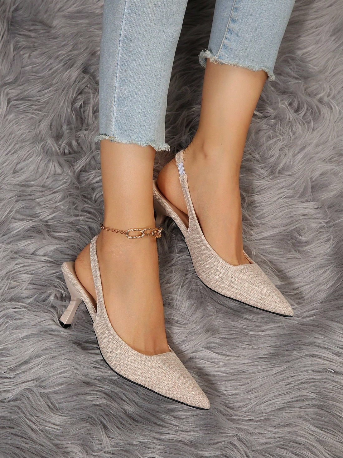 Elevate your style with our Chic Tweed Slingback Pumps. The pyramid heels provide stability while the tweed adds a touch of elegance. Perfect for modern and sophisticated looks. Own the room with confidence and comfort.