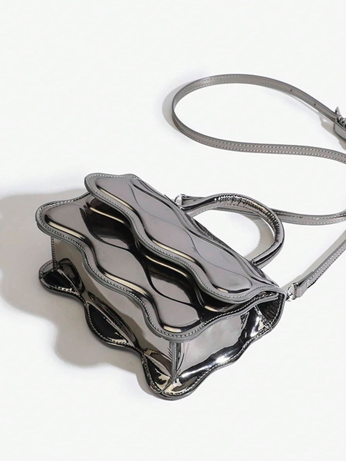 Add a splash of sparkle to your day with this Stylish Silver PU Leather Handbag! Featuring a chic wave pattern, this small tote easily transforms into a crossbody for hands-free fun. Perfect for carrying your essentials with flair, it’s the playful accessory every woman needs to brighten up any outfit.