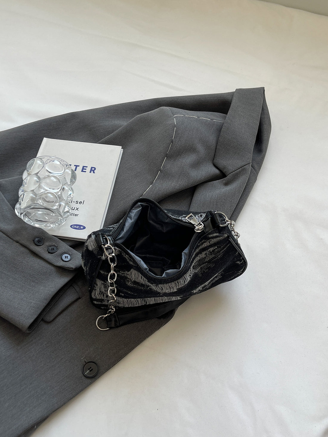 This chic denim chain shoulder bag effortlessly adds style to any occasion. With its versatile design, it's perfect for any outfit. The chain strap adds a touch of sophistication, while the spacious interior offers plenty of room for all your essentials. Elevate your wardrobe with this must-have accessory.