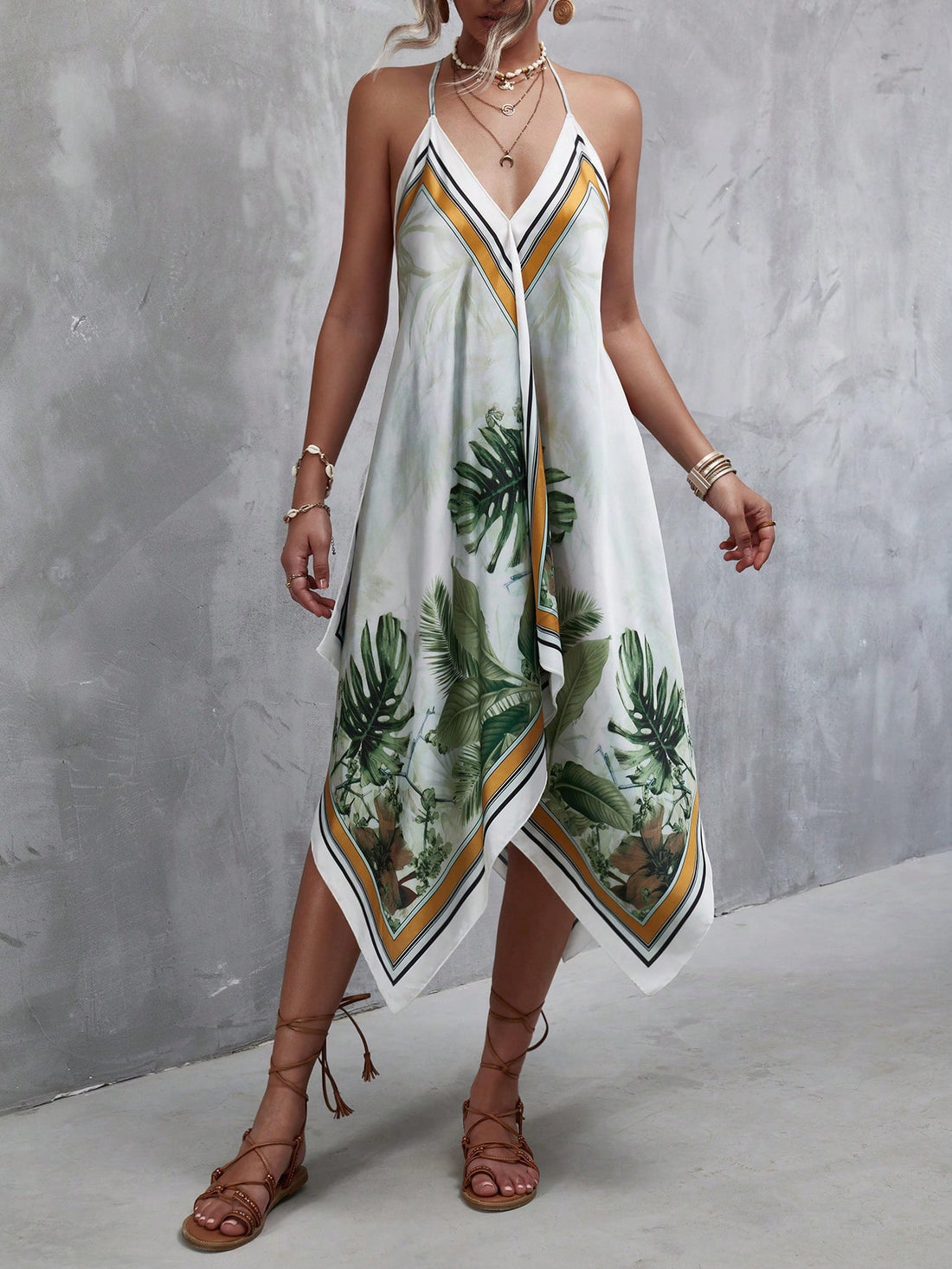 This Summer Chic: Tropical Print Hanky Hem Cami Dress is the perfect summer staple. Made with a tropical print design and a flattering hanky hem, this dress will keep you cool and stylish in the hot weather. Its lightweight and flowy material provides comfort while maintaining a chic look.