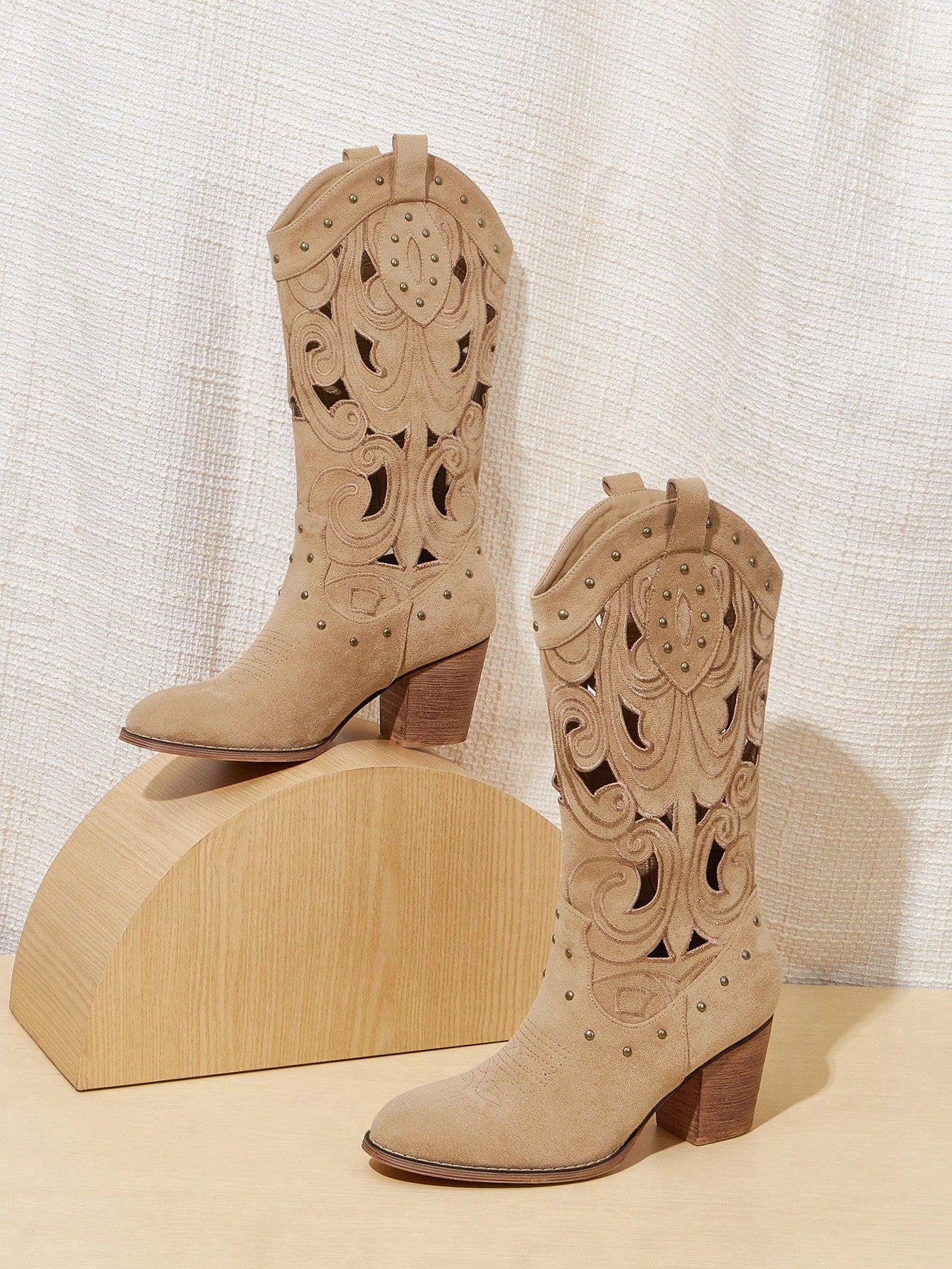 Elevate your vacation style with our Studded Suede Western Boots. These stylish and comfortable shoes are perfect for summer adventures. The studded detailing adds a touch of edge, while the suede material ensures all-day comfort. Don't miss our summer sale!