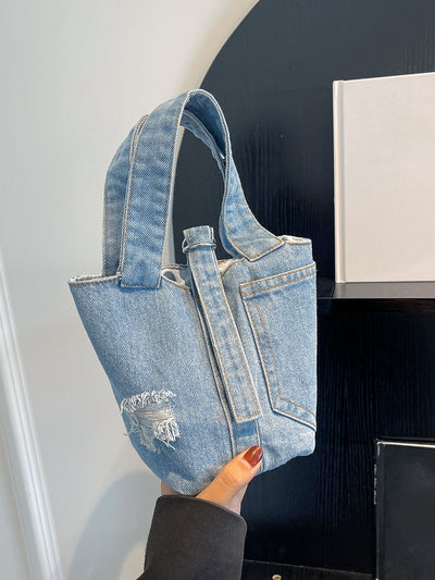 Introducing the Denim College Chic Tote Bag, the ultimate campus carry-all. Made from durable denim, this tote bag is perfect for carrying all your essentials in style. With spacious compartments and a chic design, it's the perfect accessory for any college student on the go.