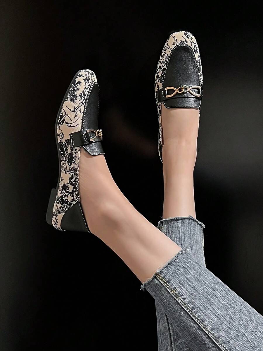 Top view of slip-on loafers showing cream floral print panels and tan insoles