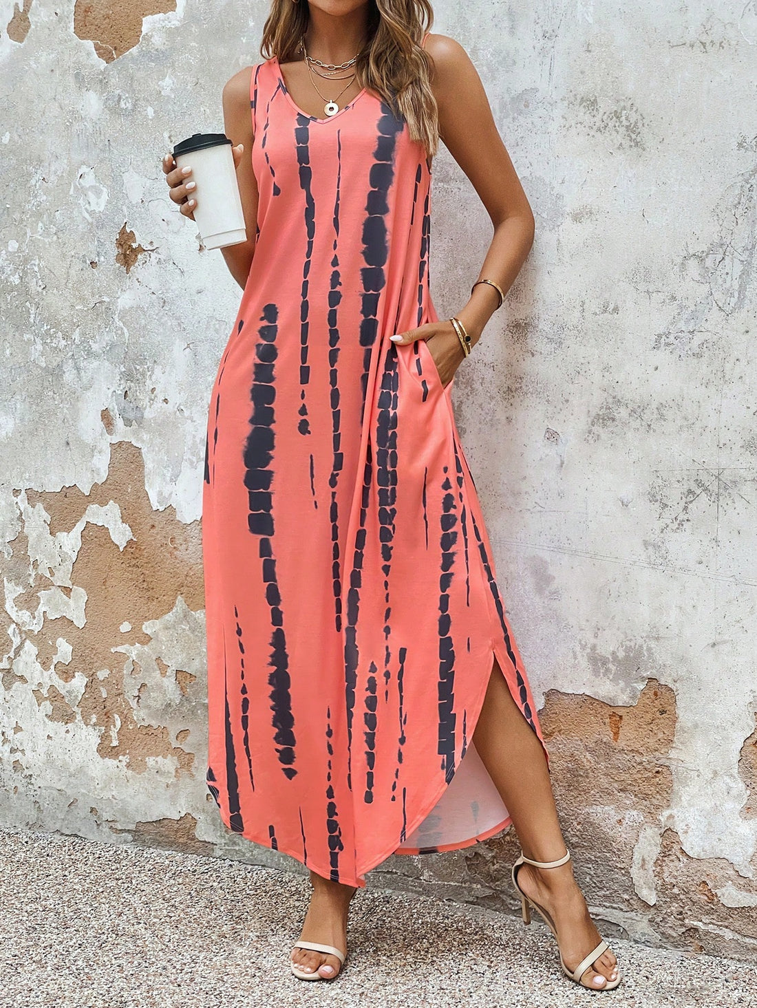 Add some fun and convenience to your wardrobe with our Chic Tie-Dye Maxi Dress! This dress features a stylish split hem, perfect for twirling, and hidden pockets for storing all your essentials. The vibrant tie-dye design adds a playful touch to any outfit.