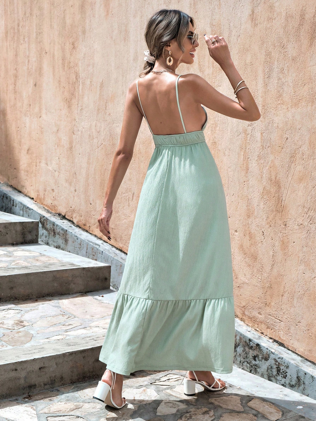 Get ready to turn heads in this playful and chic Solid Backless Ruffle Hem Cami Dress in Mint Green. The backless design adds a touch of seductiveness while the ruffle hem brings a fun and flirty element to this dress. Perfect for any occasion, this dress will make you stand out in a sea of ordinary.