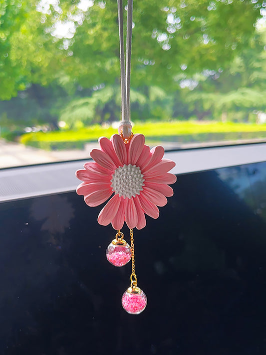 Enhance your car's interior with the Daisy Delight Car Interior Decoration. With a touch of pink on your rearview mirror, your car will feel refreshed and stylish. Made of high-quality materials, this decoration is durable and will add a playful touch to your daily commute.