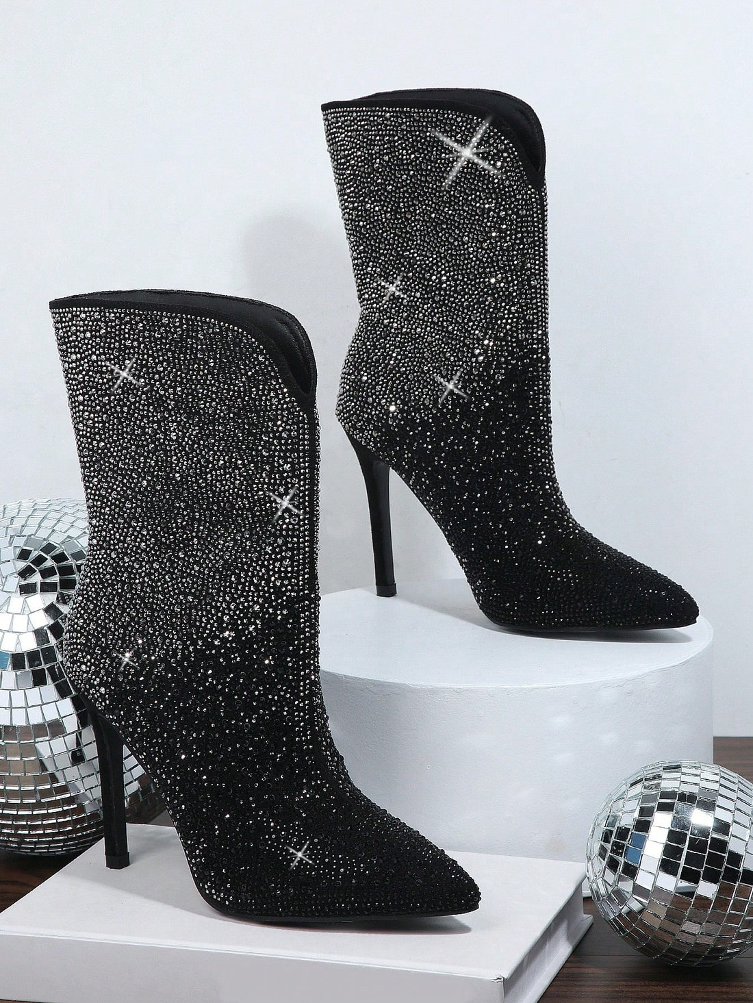 Upgrade your shoe game with our Sparkle and Shine: Rhinestone Stiletto Boots. Featuring a side zipper for easy wear, these boots will add a touch of glamour to any outfit. With rhinestone embellishments, you'll sparkle and shine all night long. Elevate your style with these statement boots.