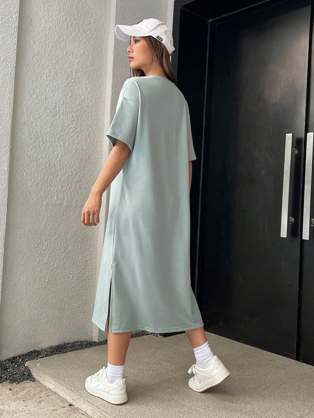 Stay effortlessly stylish in this Mint Green Drop Shoulder Tee Dress with Split Hem. The relaxed drop shoulder design and split hem add a touch of casual charm, while the refreshing mint green color adds a pop of color to your wardrobe. Perfect for any occasion, this dress is a must-have for any fashion-forward individual.