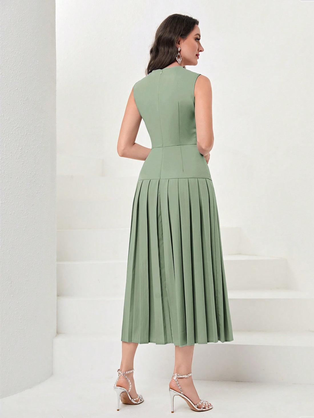 Twirl into the spotlight with this pleated-hem evening dress that's as fun as it is fancy! The flowing length creates dramatic movement while you dance the night away, and the solid color means endless accessorizing possibilities. Who says sophistication can't be playful? This dress proves you can command attention and have a blast doing it!