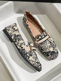 Cream toile print loafer shown in white display tray with black piping
