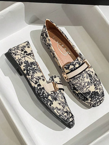 Cream toile print loafer shown in white display tray with black piping