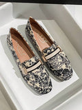 Side view of cream slip-on loafer with decorative gold buckle bit