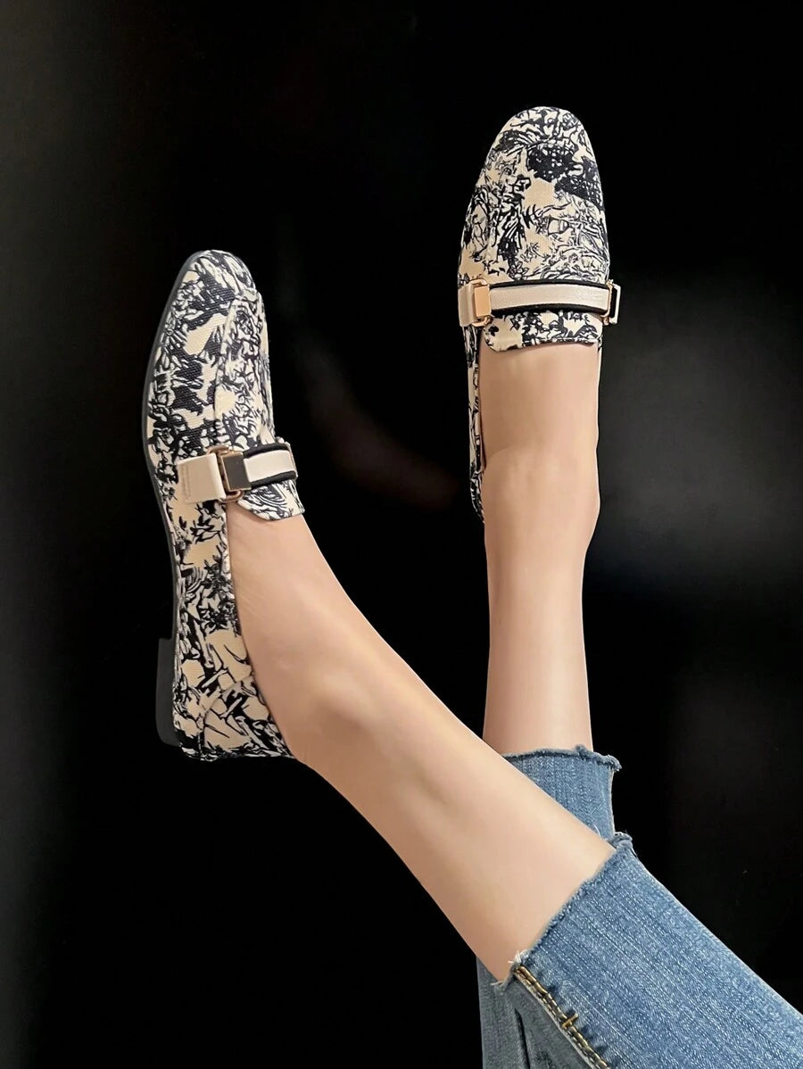 Cream PU leather loafer worn with sheer pants in indoor lifestyle shot