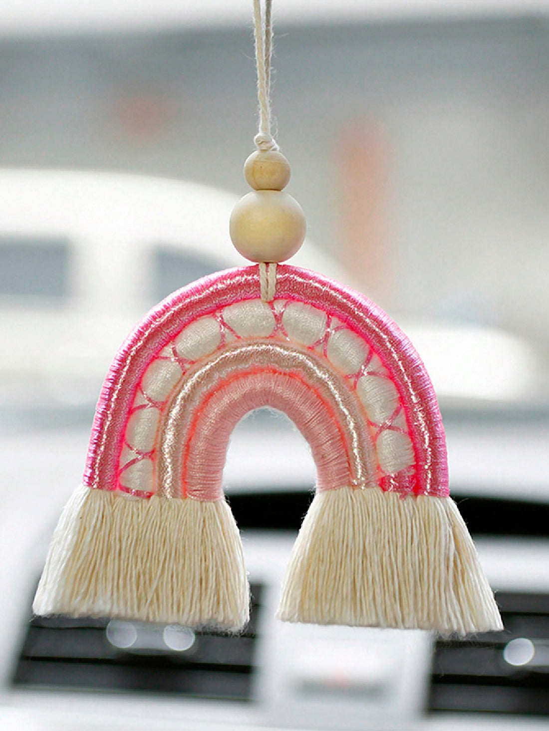 Enhance your car's interior with our Colorful Charm: Handmade Rainbow Woven Pendant. Handcrafted for a unique design, this pendant adds a splash of color to your rearview mirror. Made with vibrant woven materials, this pendant is the perfect accessory to brighten up any drive.