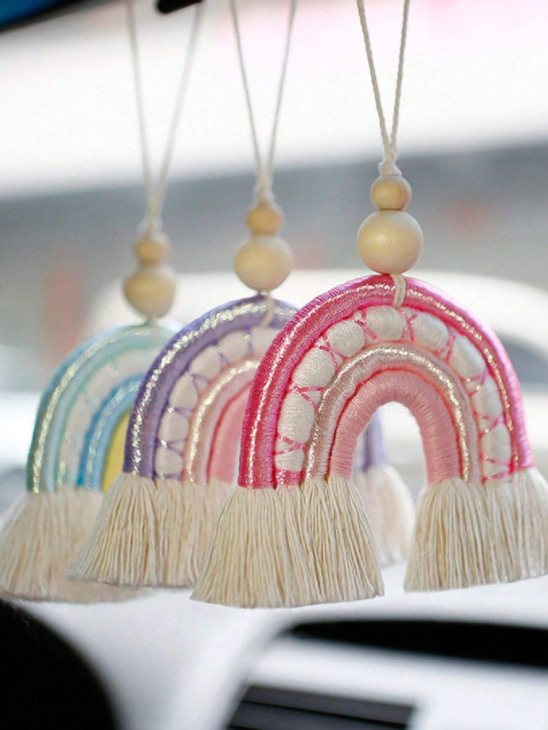 Enhance your car's interior with our Colorful Charm: Handmade Rainbow Woven Pendant. Handcrafted for a unique design, this pendant adds a splash of color to your rearview mirror. Made with vibrant woven materials, this pendant is the perfect accessory to brighten up any drive.