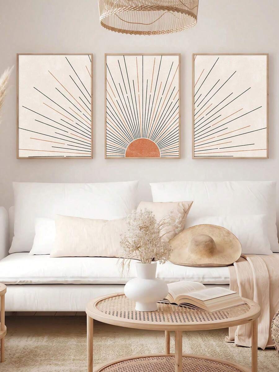 Angled living room mockup of three apricot sunrise prints in light wood display frames