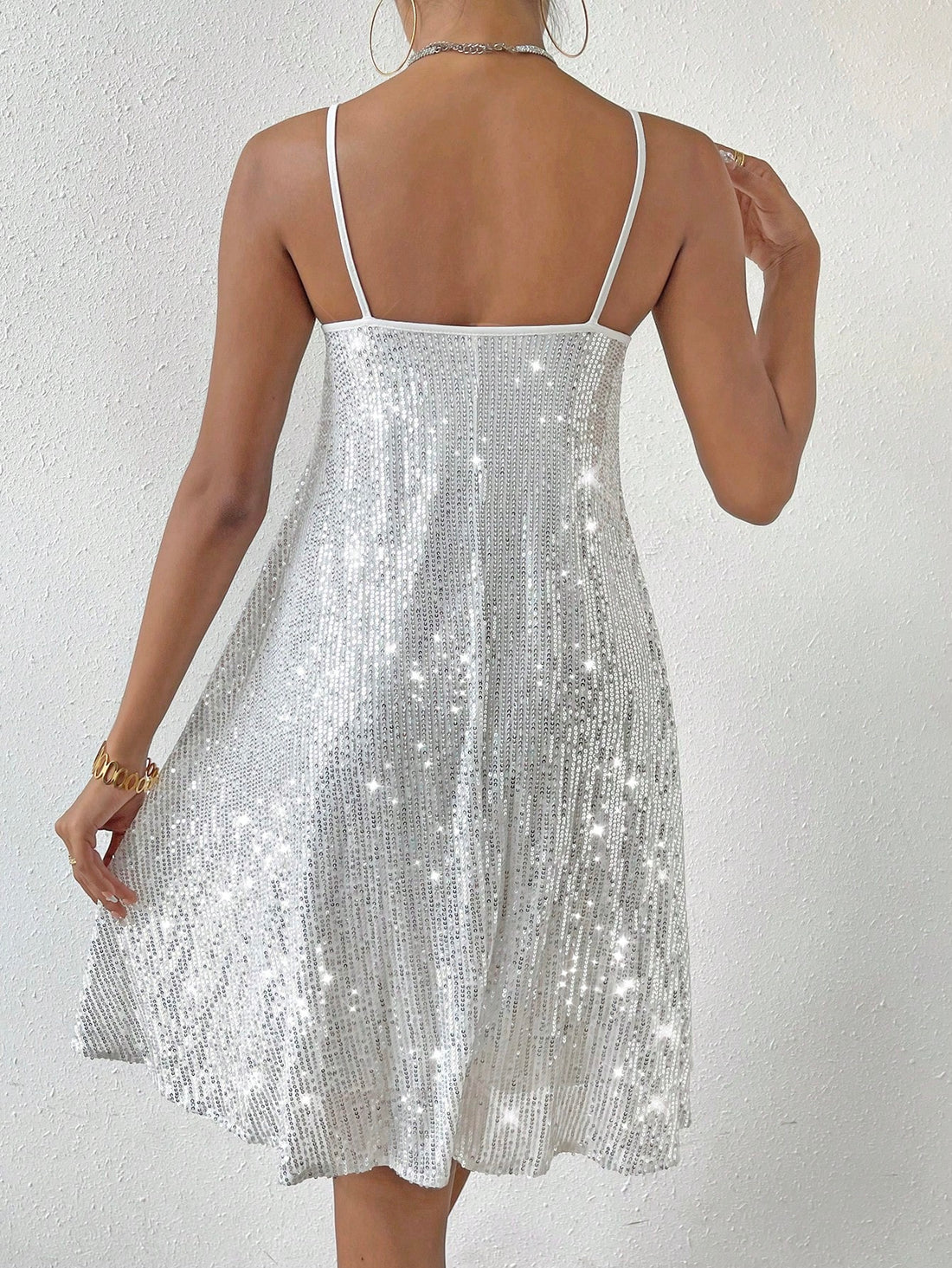 This Shimmering Elegance cami dress will bring a touch of glamour to any occasion with its shimmering sequin decor. The flattering cami style will accentuate your figure, while the subtle shimmer adds a touch of elegance. Perfect for any special event, this dress will make you stand out in style.