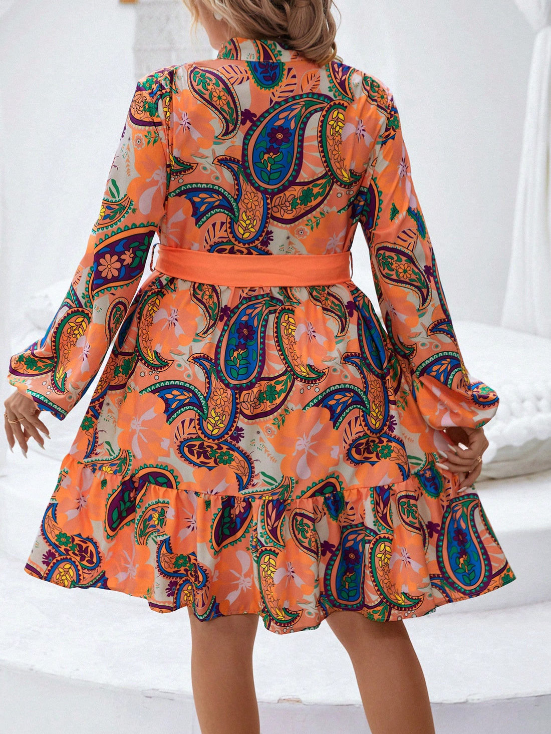 Stun in this elegant paisley print dress designed for plus sizes. Beautiful lantern sleeves and a ruffled hem add a touch of sophistication, while the belted waist accentuates your curves. Perfect for any formal occasion, this dress is sure to make you stand out.