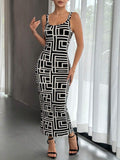 Front view of black and white geometric bodycon midi dress indoors