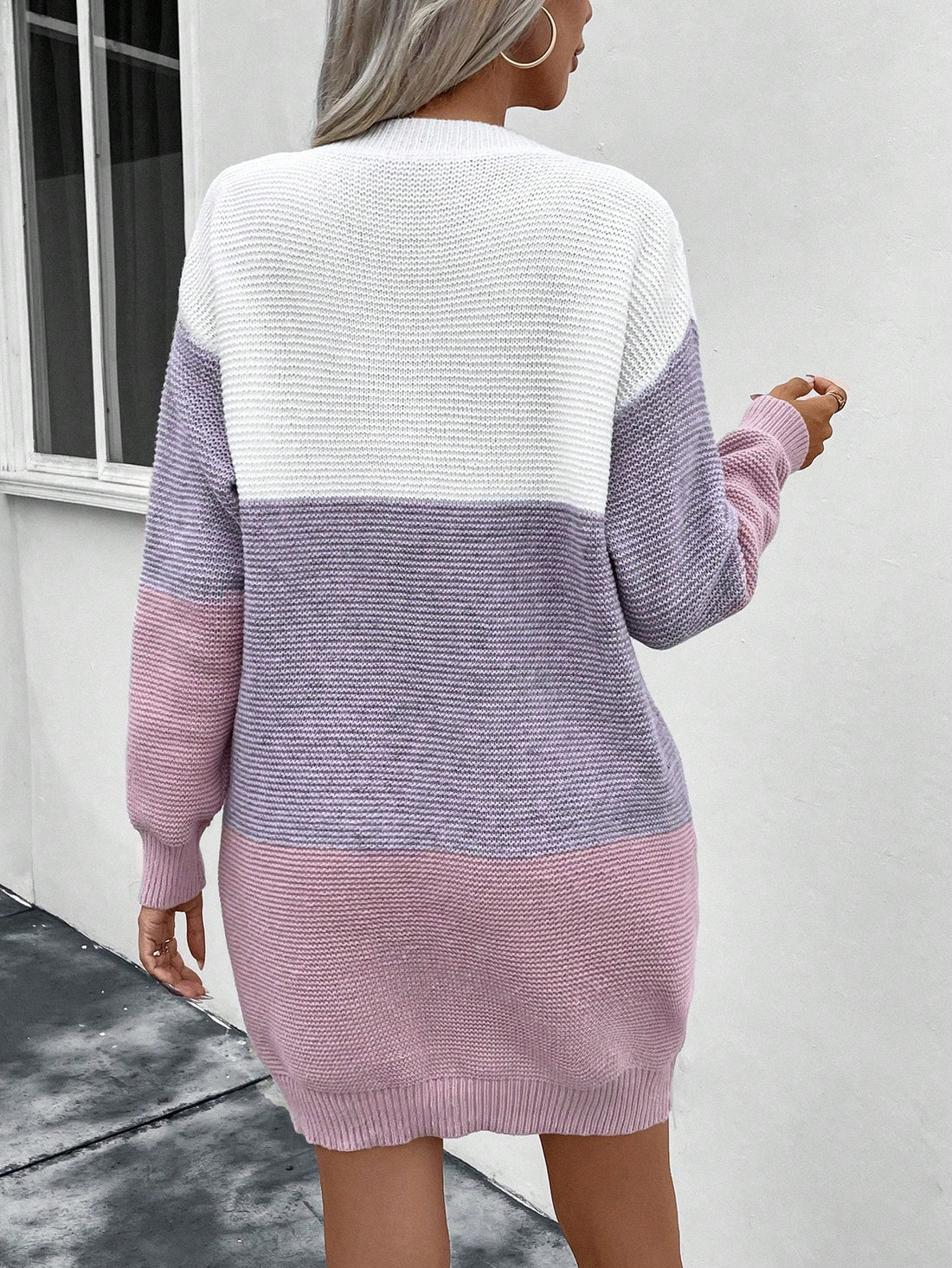 This drop shoulder sweater dress features a trendy color block design for a stylish and effortless look. Made from high-quality materials, it offers both comfort and style for any occasion. Elevate your wardrobe with this must-have fashion piece.