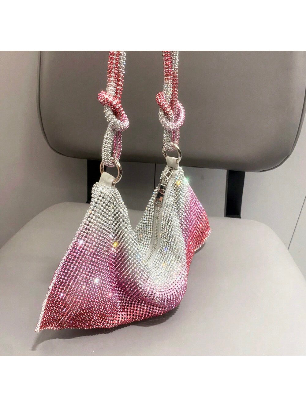 The Shimmering Rhinestone Clutch is the perfect accessory for any evening party. With its dazzling rhinestone design and detachable shoulder chain, it adds a touch of glamour to any outfit. Make a statement and stand out from the crowd with this must-have clutch.