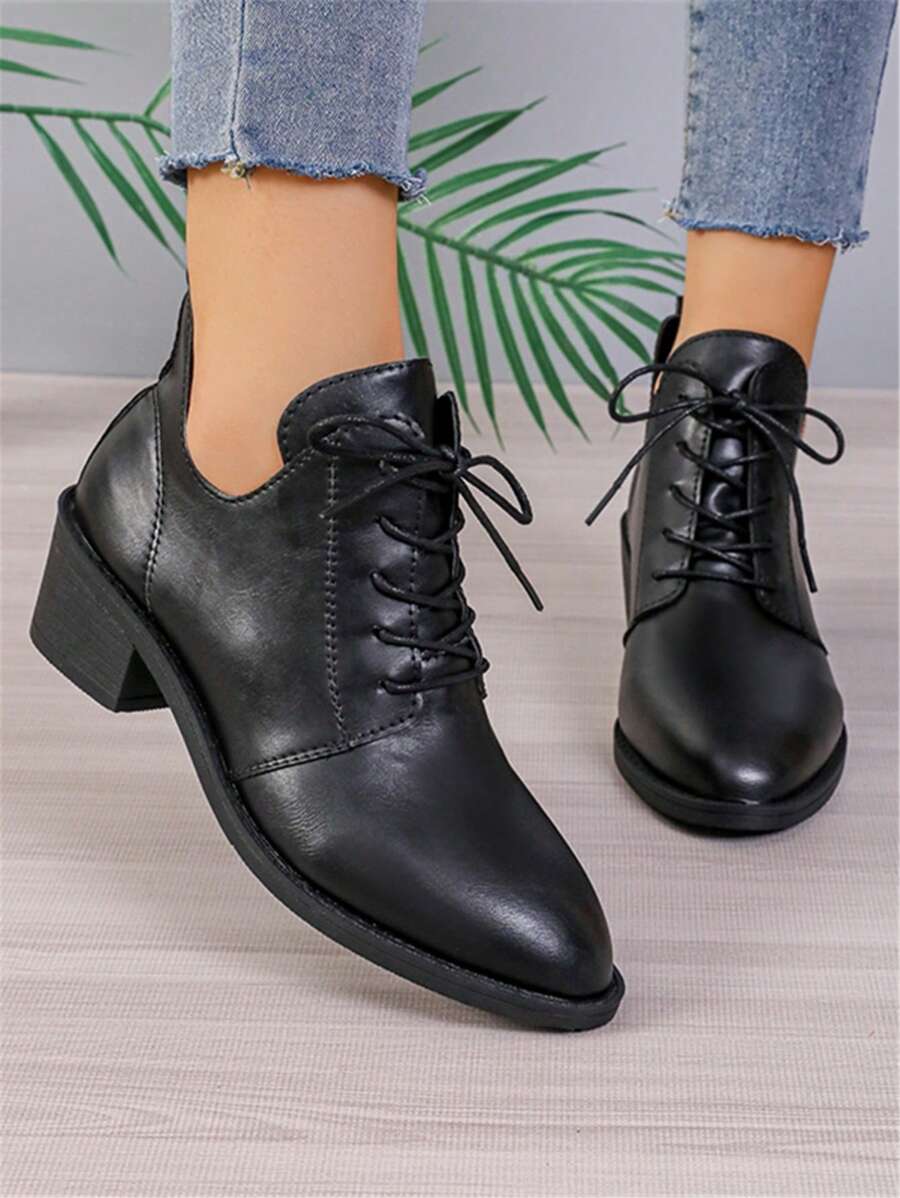 Step into sophistication with these show-stopping black ankle boots that mean business. The sharp pointed toe elongates your silhouette while the chunky heel keeps you grounded and comfortable all day long. Lace-up detailing adds an edgy, rebellious vibe that works just as hard as you do. Perfect for transitioning from spring's fresh vibes to autumn's moody aesthetic, these boots are the versatile wardrobe essential that'll have you feeling like the main character in every room. Dress them up with a little 